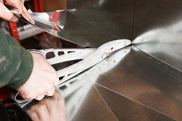 Hand-bending sheet metal for a custom HVAC plenum